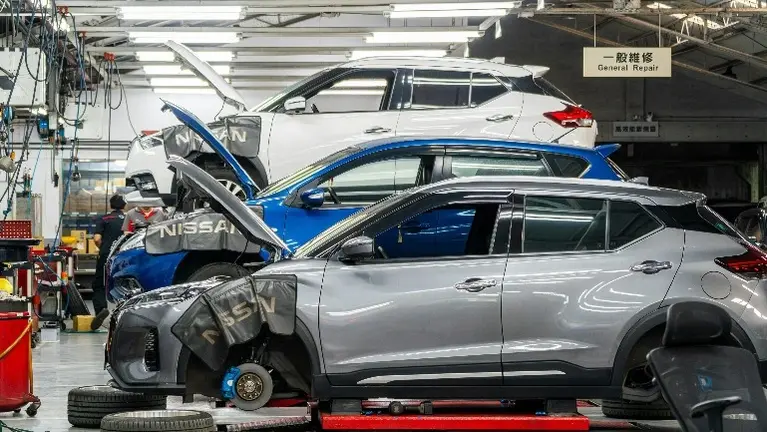 Vehicles lined up in an active repair bay
